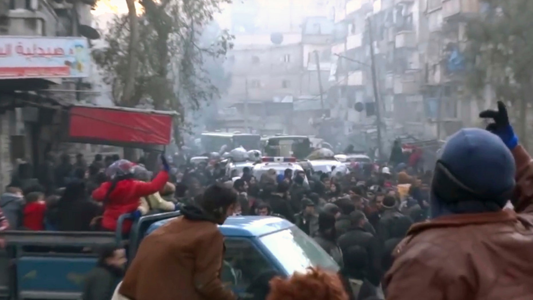 This frame grab from video provided by Baladi News Network, a Syrian opposition media outlet that is consistent with independent AP reporting, shows civilians gathering for evacuation from eastern Aleppo, Syria, Thursday, Dec. 15, 2016.