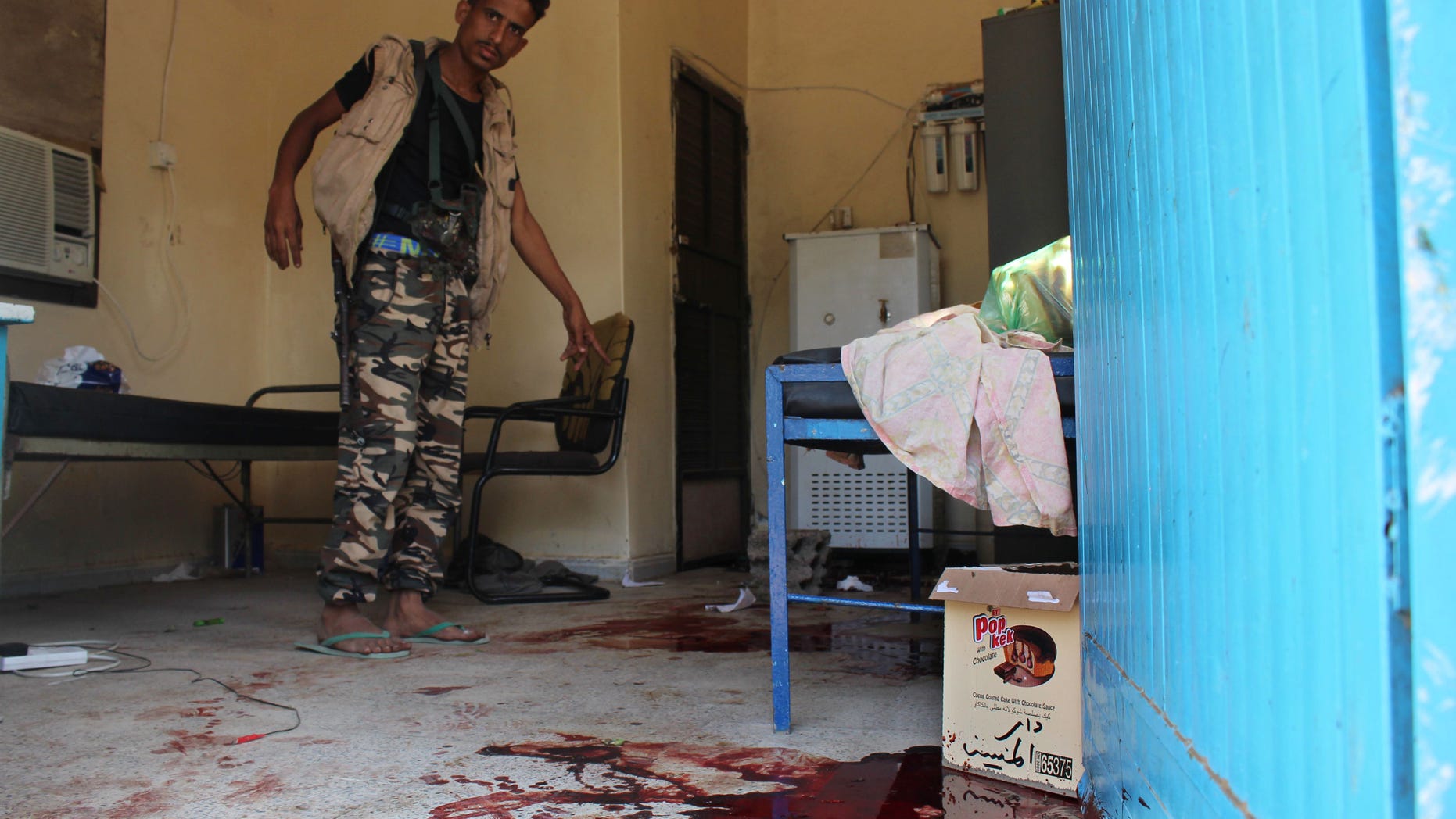 A Yemeni man inspects an elderly care home that was attacked Friday by unidentified gunmen.