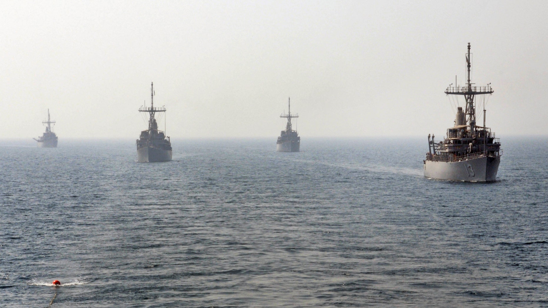 Aug. 29, 2012: This handout photo released by the U.S. Navy, 5th Fleet, shows USS Navy mine counter measure ships, from right to left, USS Dextrous , USS Sentry, USS Devastator and USS Pioneer get in line to conduct an astern replenishment-at-sea.