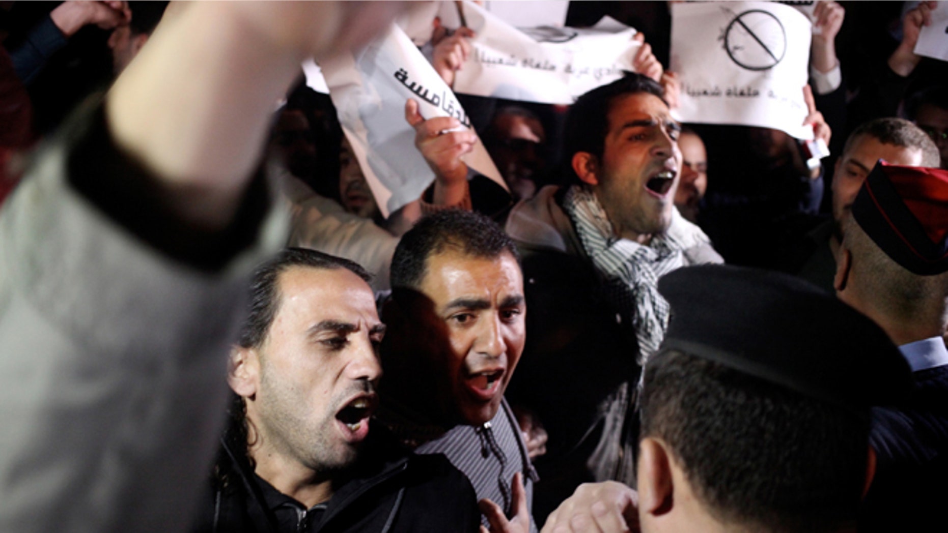 Mar. 10, 2014: Jordanian protesters shout slogans across the street from the Israeli embassy and demand the deportation of the Israeli ambassador after the killing of Jordanian judge Raed Zueter, 38, at Allenby crossing between Jordan and the West Bank, in Amman, Jordan.