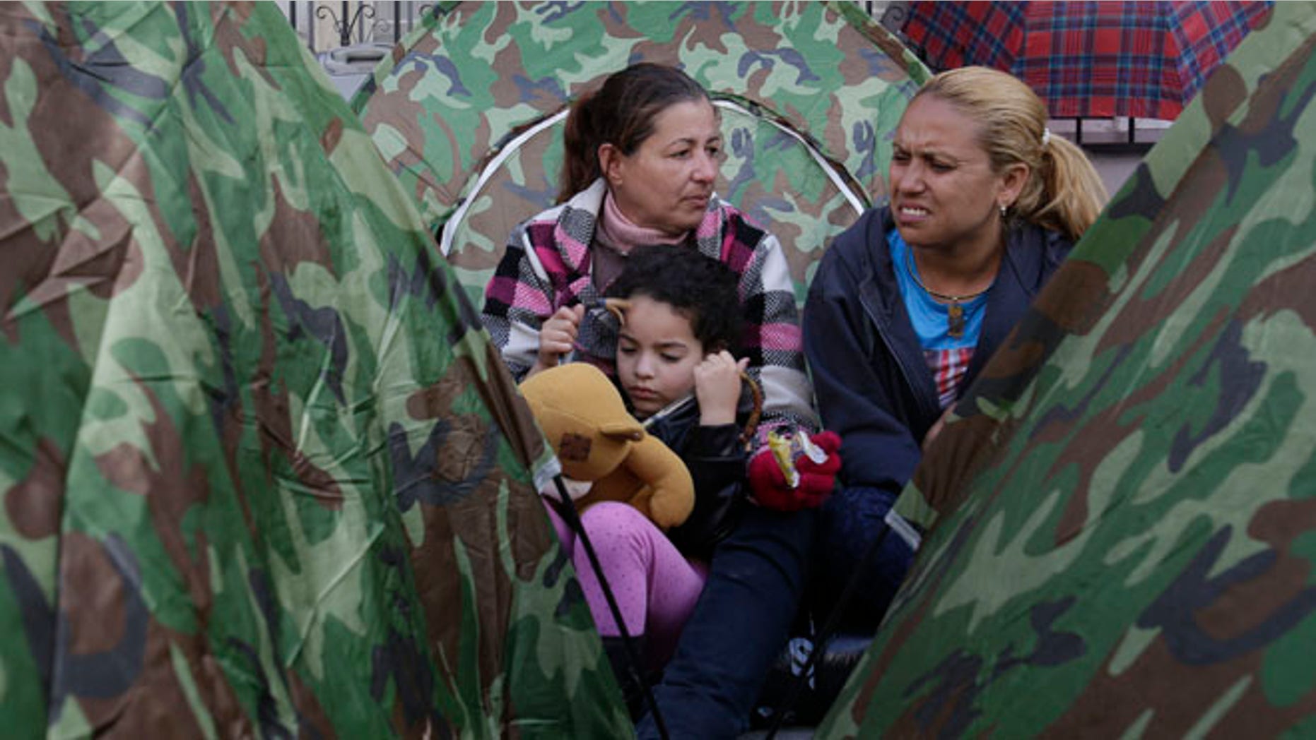 Dozens of Cubans are camped out in front of Mexico's embassy appealing for help in reaching the United States, in Quito, Ecuador, Tuesday, June 21, 2016. They apparently seek something like an international operation earlier this year that lifted thousands of Cubans from Costa Rica to Mexico, so that they could reach the U.S. Unlike any other nationality, Cubans are essentially granted residence if they reach U.S. territory. (AP Photo/Dolores Ochoa)