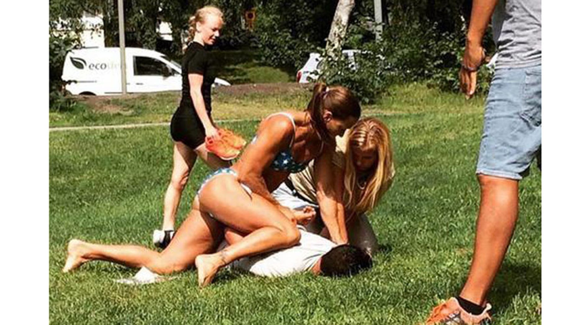 Swedish police officer Mikaela Kellner is snapped pinning a suspected thief to the ground. (Jenny Kitsune Adolfsson via AP)