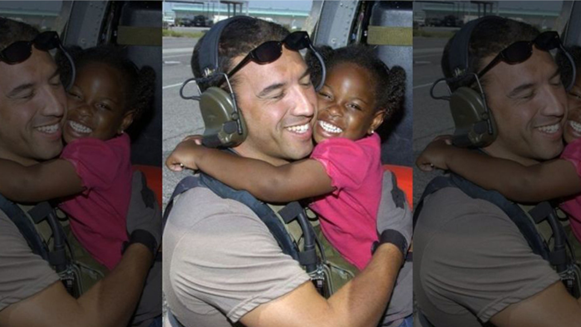 Air Force Reserve Master Sgt. Mike Maroney hugs 3-year-old he rescued in aftermath of Hurricane Katrina in 2005. (U.S. Air Force)