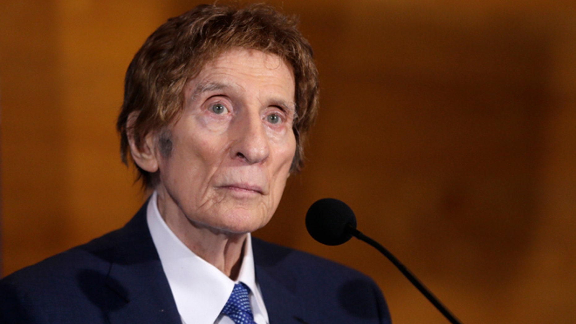 FILE- In a file photo from Nov. 14, 2014, Detroit Tigers owner Mike Ilitch listens during a news conference in Detroit. Ilitch, the owner of the Detroit Red Wings and Tigers, who founded the Little Caesars Pizza empire, has died.
