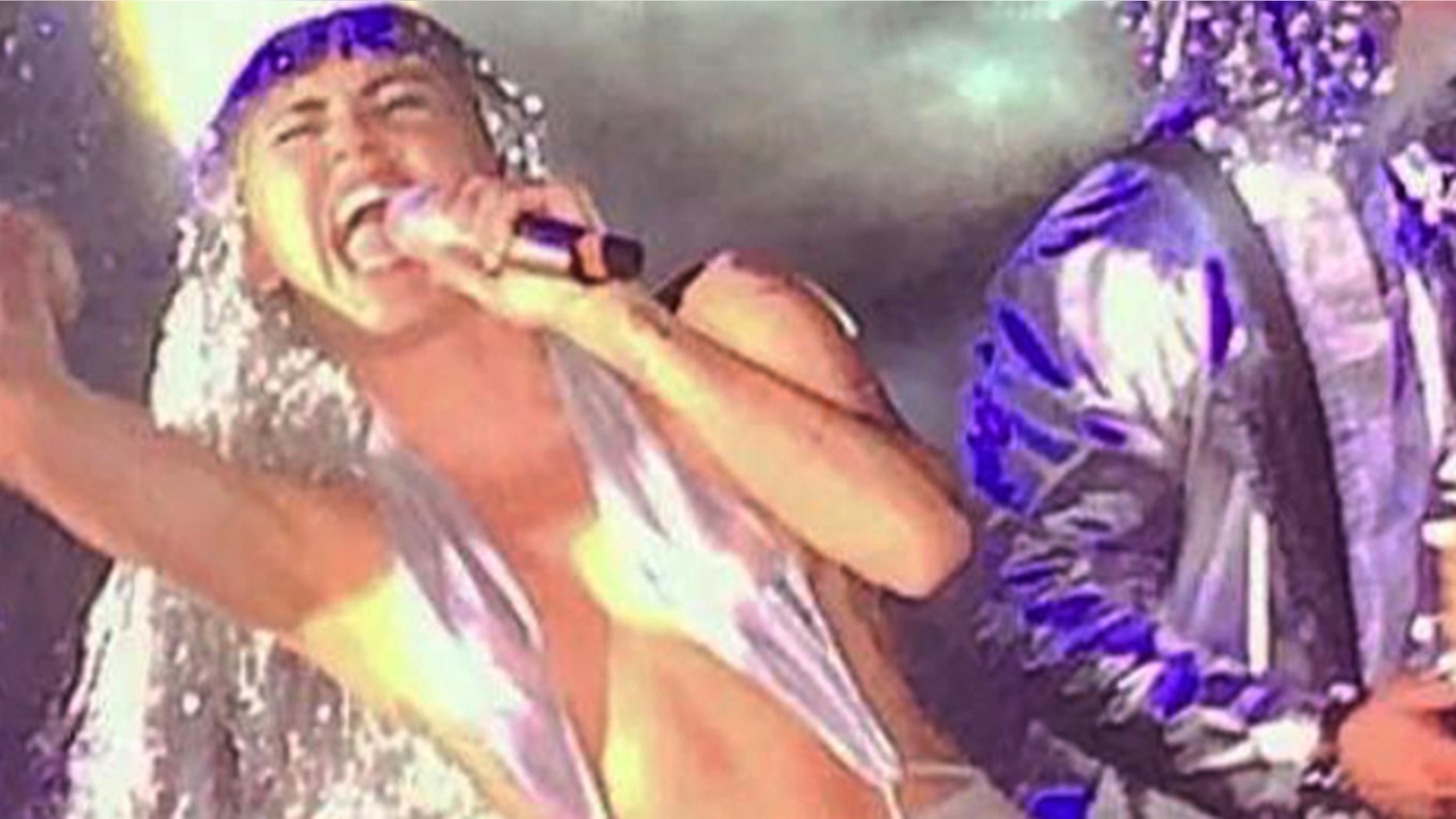 In this Wednesday, Dec. 3, 2014 photo provided by Lesley Abravanel, Miley Cyrus performs during a poolside show at the Raleigh Hotel, in Miami Beach, Fla. In a bizarre and emotionally transparent performance, Cyrus mocked her own music, opened up about her dark year, belted some Led Zeppelin and smoked pot onstage. (AP Photo/Lesley Abravanel)