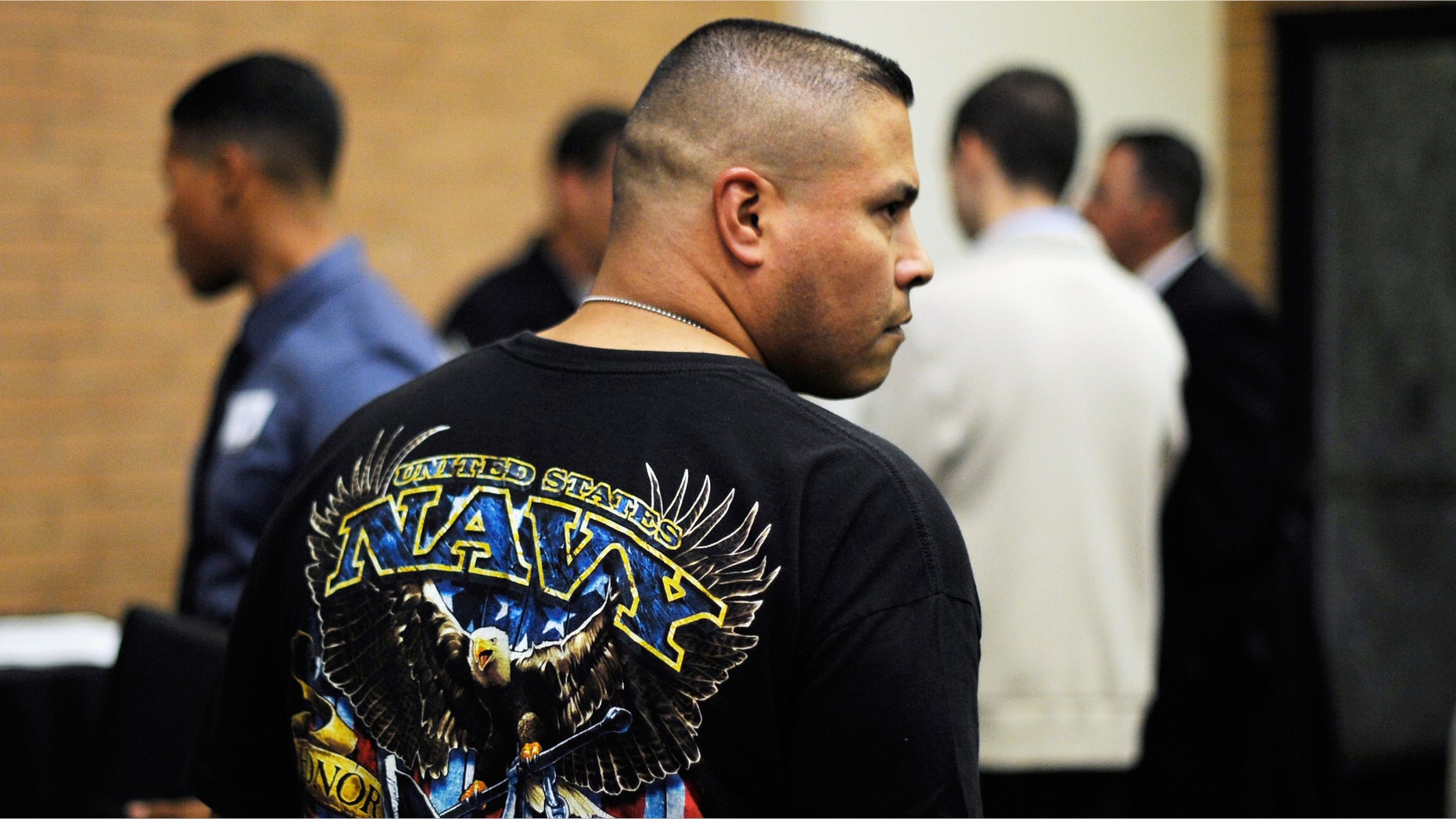 A veteran listens to a speaker as he looks at job openings during a jobs fair for veterans. (Photo by Kevork Djansezian/Getty Images)