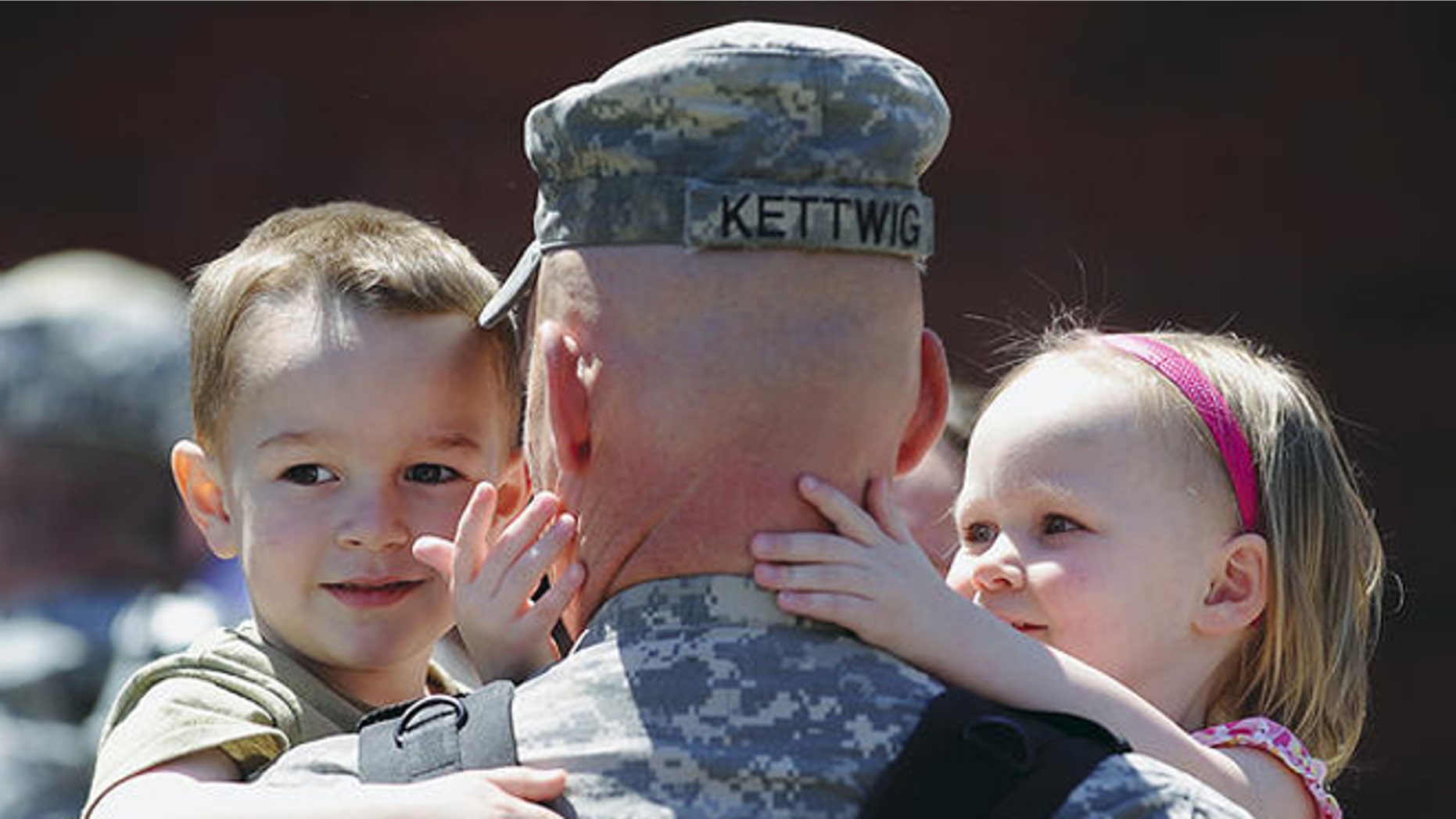 2011: Maj. Jason Kettwig of Milbank, S.D., greeted his children at a Sioux Falls, S.D., homecoming on May 3. (Elisha Page/Argus Leader/AP)
