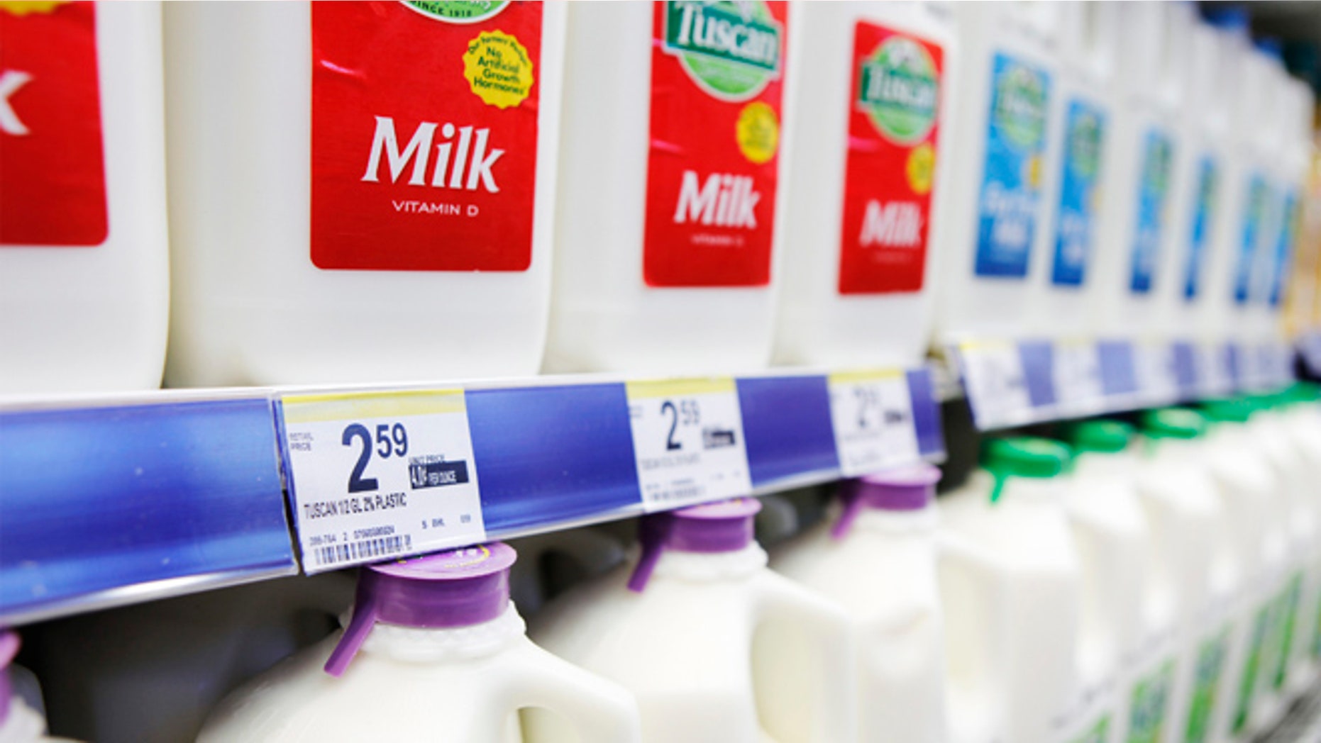 Price labels of half gallons of milk for sale are seen in a store in New York April 7, 2011.
