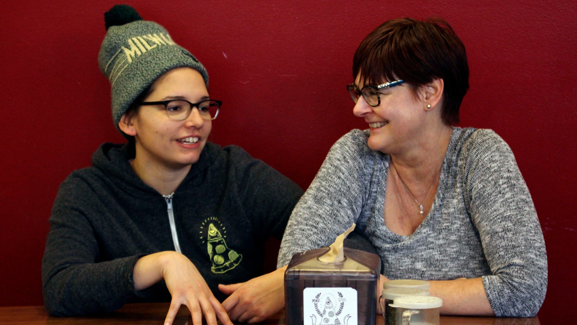 In this Jan. 9, 2017, photo, Andrea Ledesma, left, talks with her mother, Cheryl Romanowski, at Classic Slice pizza restaurant, where Ledesma works, in Milwaukee.
