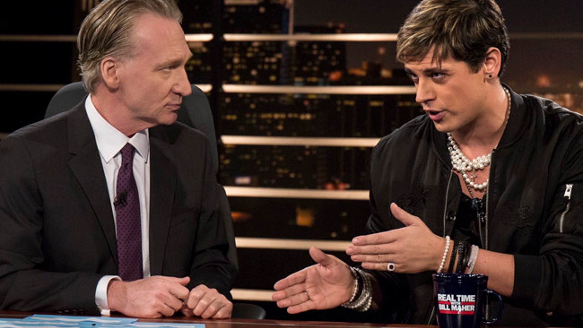 In this photo provided by HBO, host Bill Maher, left, listens to Milo Yiannopoulos, a writer for Breitbart News, on HBO's "Real Time with Bill Maher," Friday, Feb. 17, 2017, in Los Angeles. (Janet Van Ham/HBO via AP)