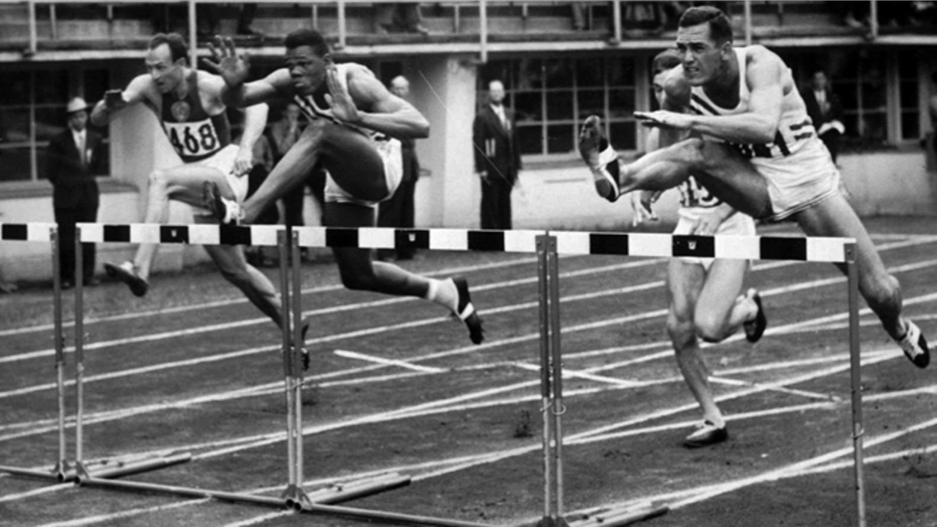 July 26, 1952: This file photo shows Milt Campbell, center, of Plainfield, N.J. getting set to clear the final hurdle to make him the winner in the fifth heat of the 110-meter hurdles event in the Olympic decathlon at Helsinki, Finland.