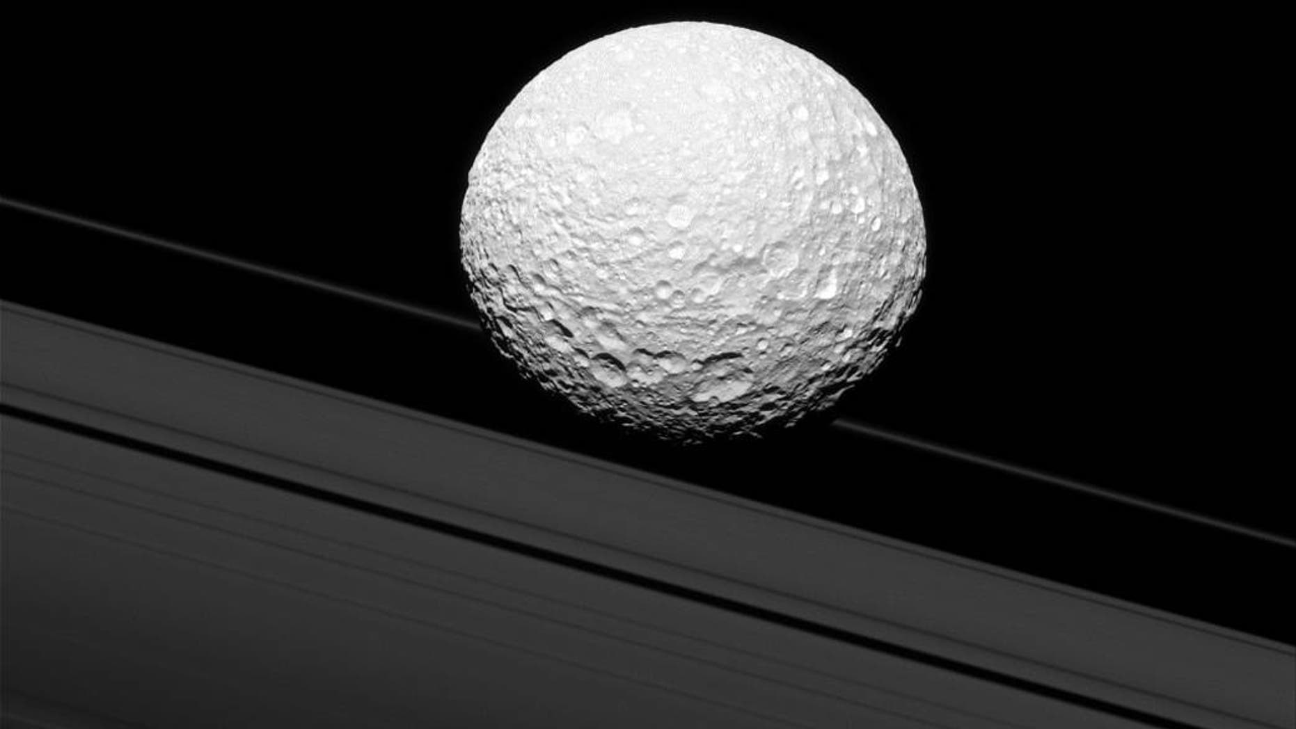 Mimas, one of Saturn's moons, seems to be on a collision course with the planet's rings. No fear though, it's simply an illusion in this image snapped by NASA's Cassini spacecraft. (Credit: NASA/JPL-Caltech/Space Science Institute)