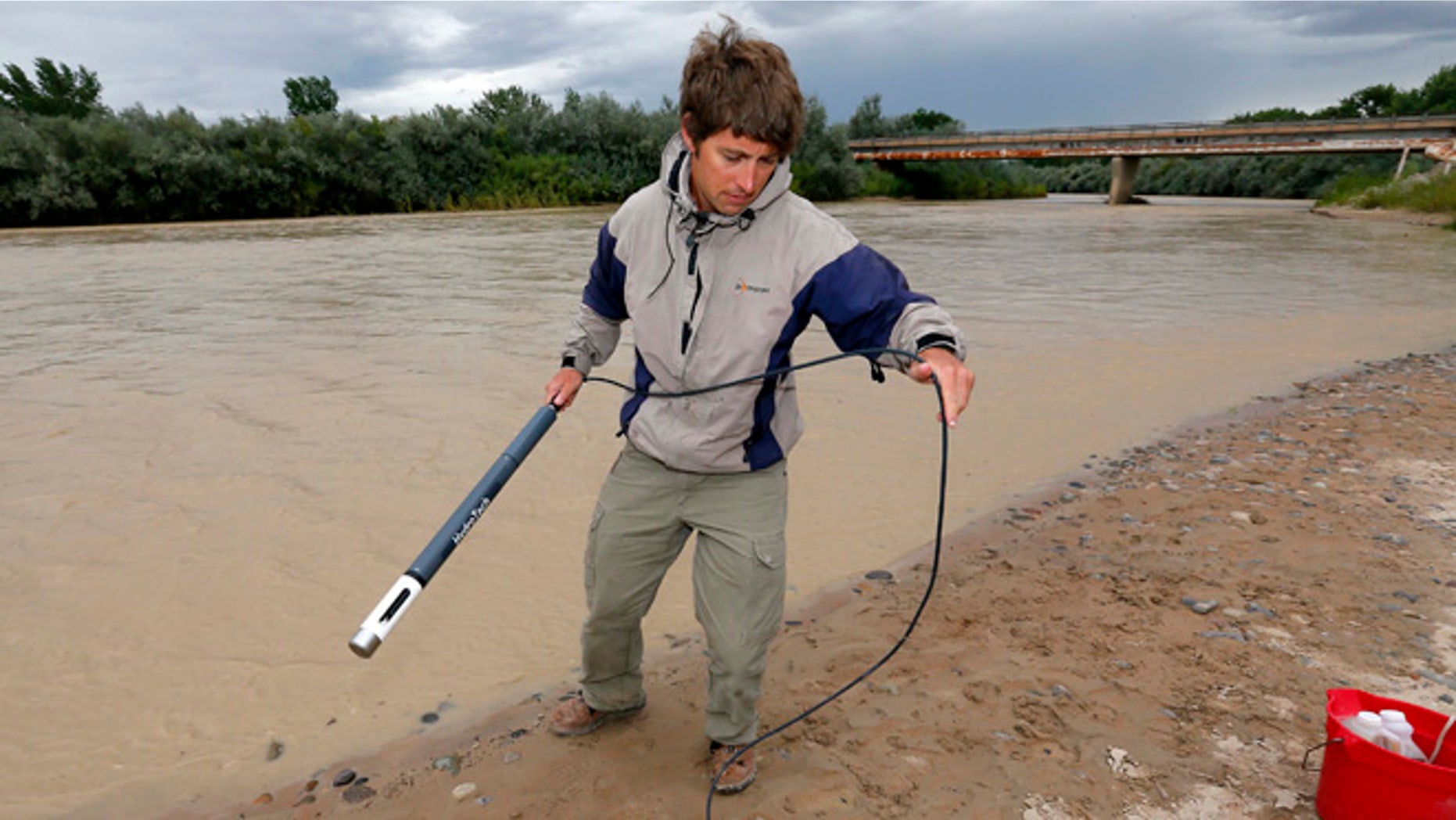 Aug. 11, 2015: Ben Brown, with the Utah Department of Environmental Quality, takes a pH level reading from a probe in the San Juan River Montezuma Creek, Utah.