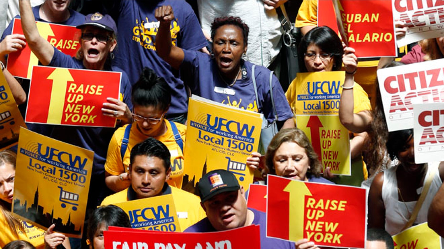 FILE: June 17, 2014: Protesters rally for an increase in the minimum wage on the Great Western Staircase at the capitol, in Albany, N.Y.