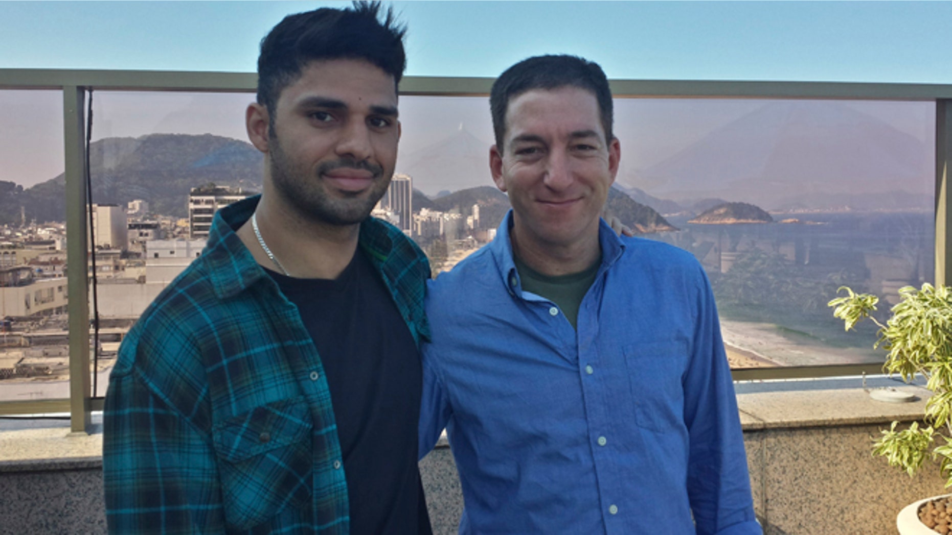 In this undated photo released by Janine Gibson of The Guardian, Guardian journalist Glenn Greenwald, right, and his partner David Miranda, are shown together at an unknown location. Miranda, the partner of Greenwald, a journalist who received leaks from former National Security Agency contractor Edward Snowden, was detained for nearly nine hours Sunday, Aug. 18, 2013, under anti-terror legislation at Heathrow Airport, triggering claims that authorities are trying to interfere with reporting on the issue.