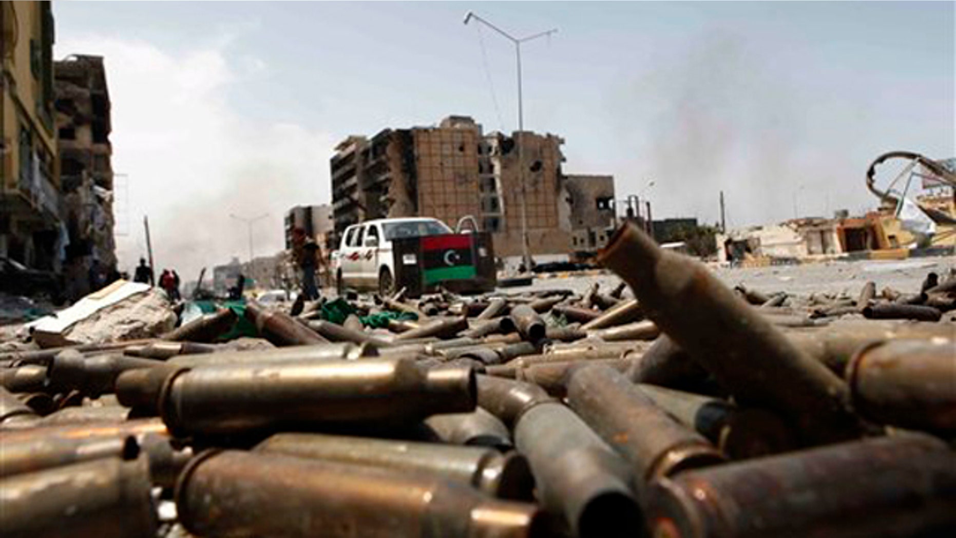 In this April 23 file photo, bullet casings litter a street in the besieged city of Misrata, Libya.