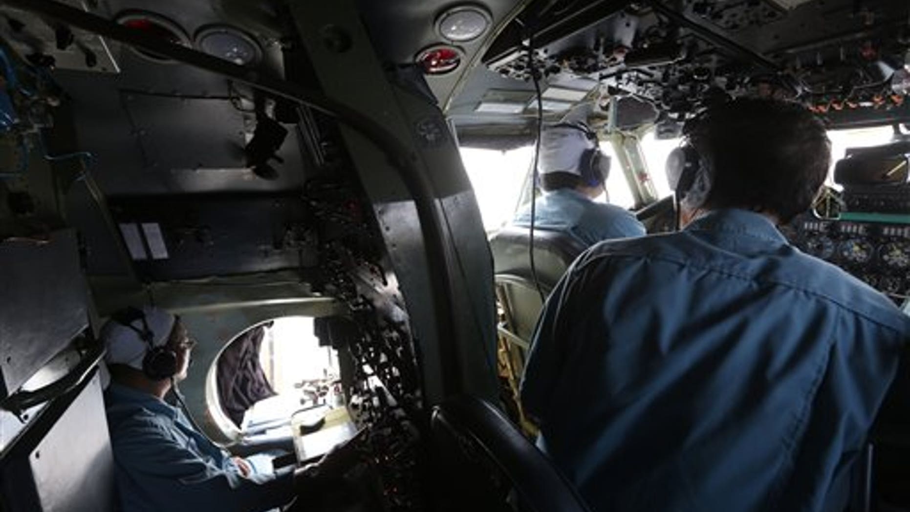 A cabin crew of Division 918 of the Vietnam Air Force is onboard a flying Soviet-made AN-26 during a search operation for the missing Malaysian Airlines Boeing 777 over the South China Sea Monday, March 10, 2014. Dozens of ships and aircraft have failed to find any piece of the missing Boeing 777 jet that vanished more than two days ago above waters south of Vietnam as investigators pursued "every angle" to explain its disappearance, including hijacking, Malaysia's civil aviation chief said Monday. (AP Photo/Na Son Nguyen)