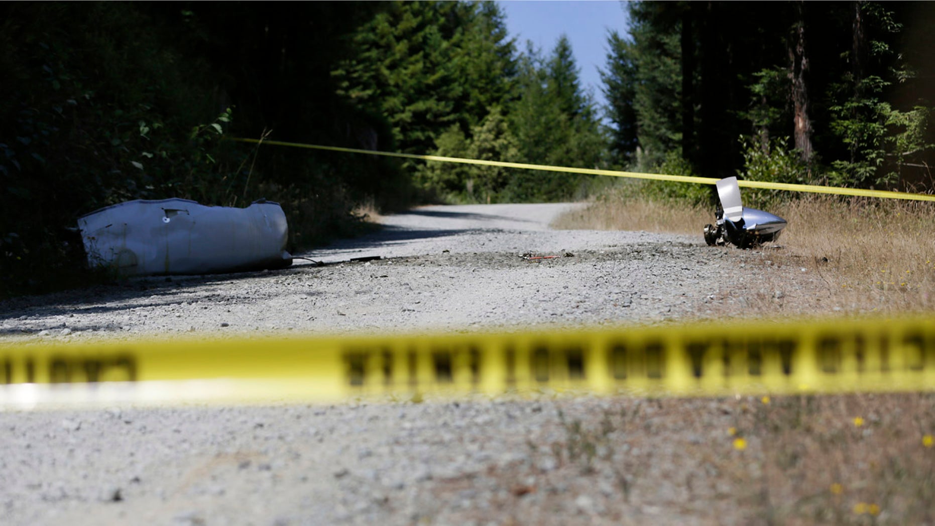 July 29, 2016: An engine nose cone with a bent propeller blade and other wreckage from a medical transport plane that crashed are shown on a road east of Crannell, Calif.