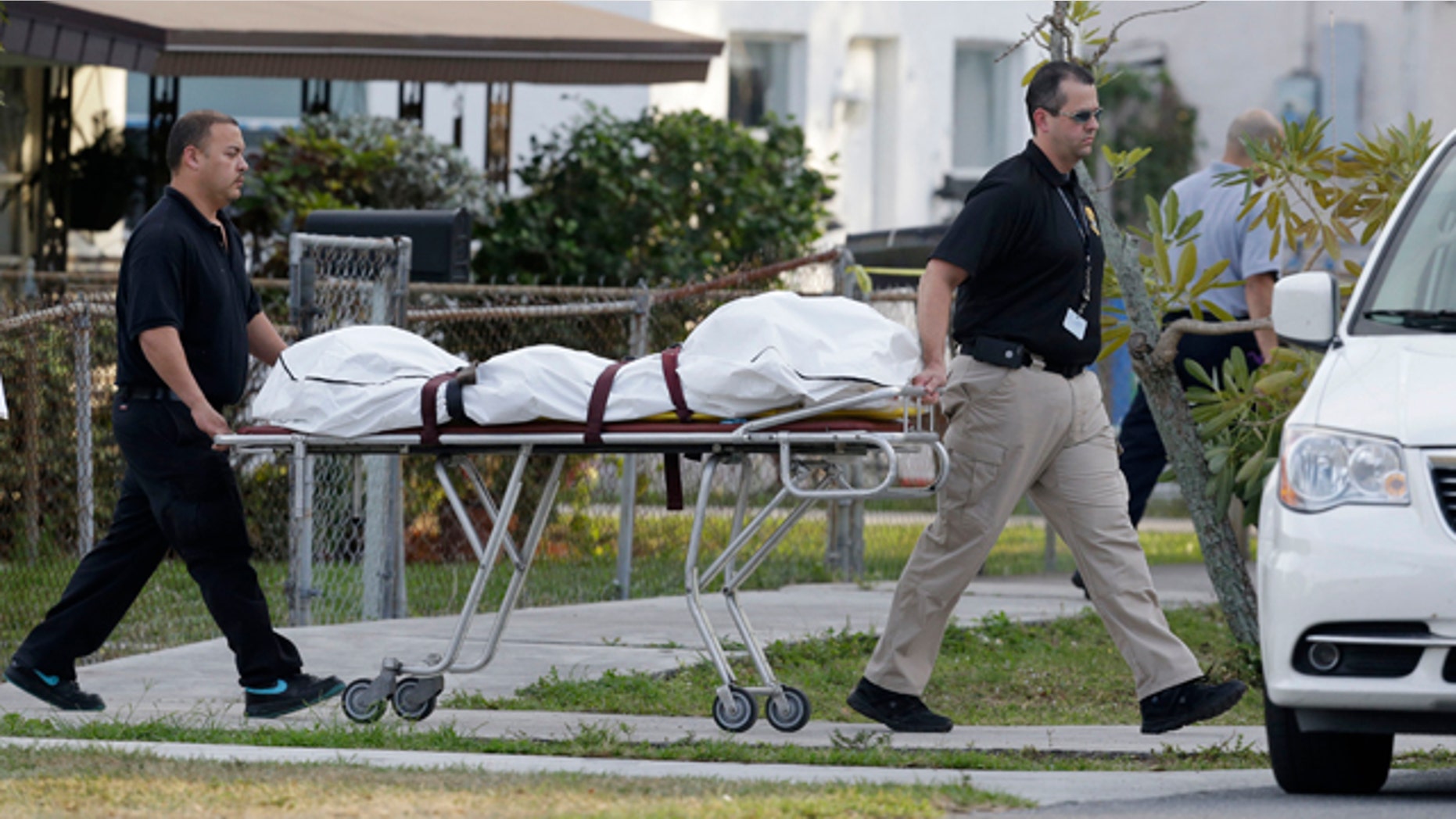 Jan. 11, 2013: Personnel from the Broward County, Fla., medical examniners office remove what are believed to be human remains that were found in the former backyard of a couple whose baby hasn't been seen in more than a year.