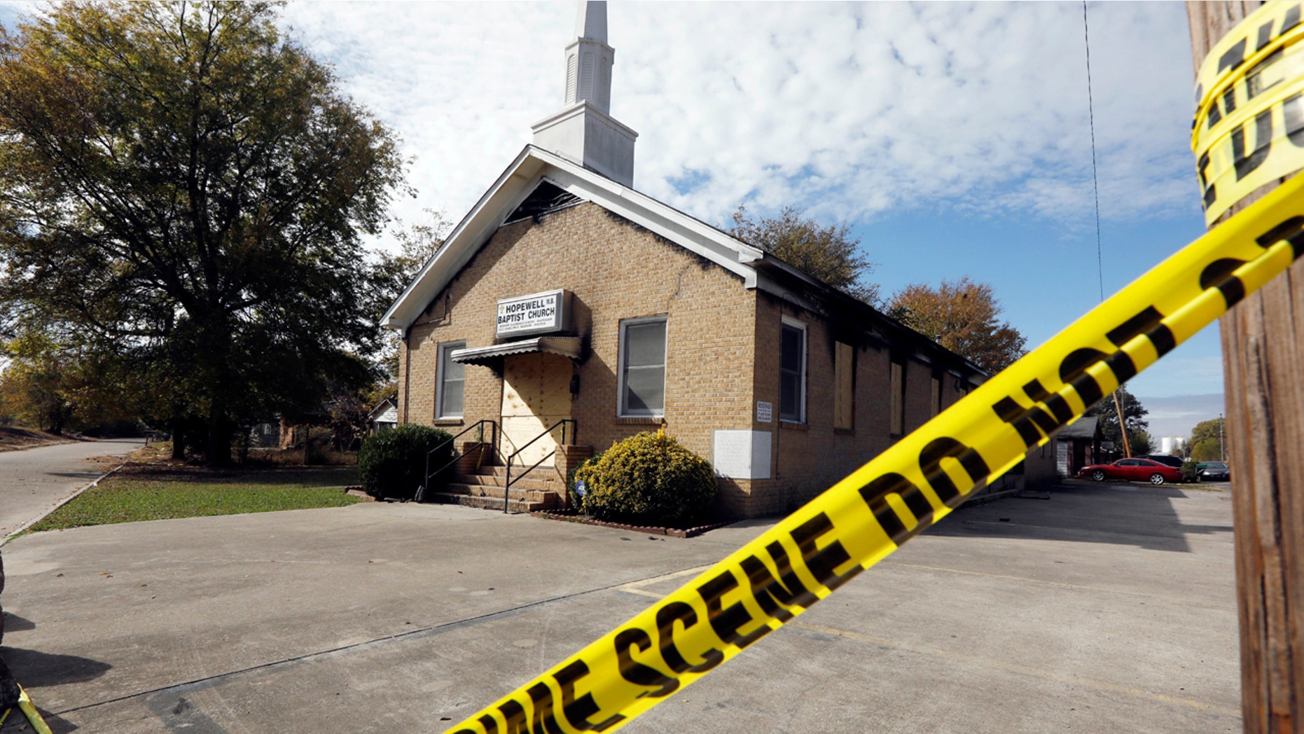 Crime scene tape outlines the perimeter of the Hopewell Missionary Baptist Church in Greenville, Miss., on Tuesday, Nov. 22, 2016, after the church was burned and spray-painted with "Vote Trump," three weeks ago. T