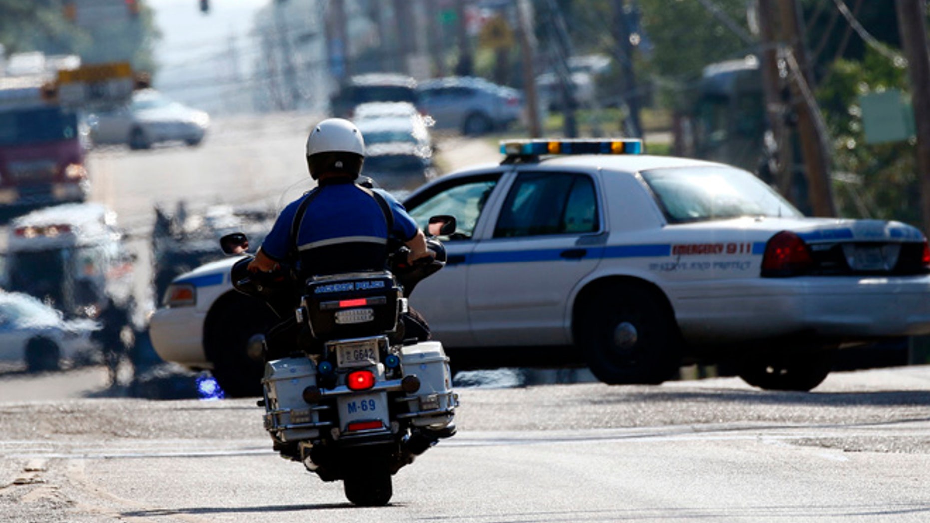 A police presence remains in a south Jackson, Miss., neighborhood, Thursday, Sept. 22, 2016, while lawmen continue to negotiate with a man suspected of holding about a dozen people against their will.