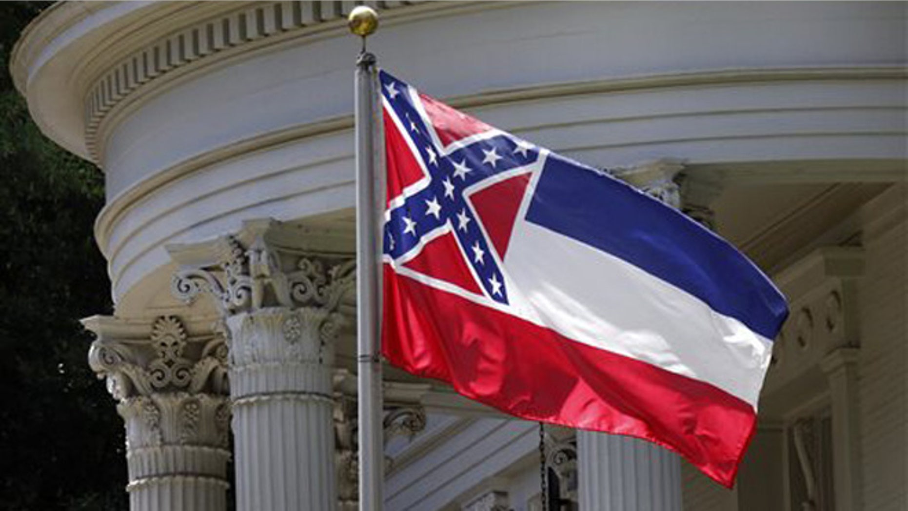 In this photo, the Mississippi state flag is unfurled against the front of the Governor's Mansion in Jackson, Miss.