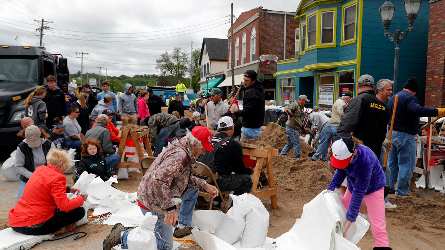 Volunteers fill sandbags in an effort to protect buildings from potential floodwater Monday, May 1, 2017, in Eureka, Mo.
