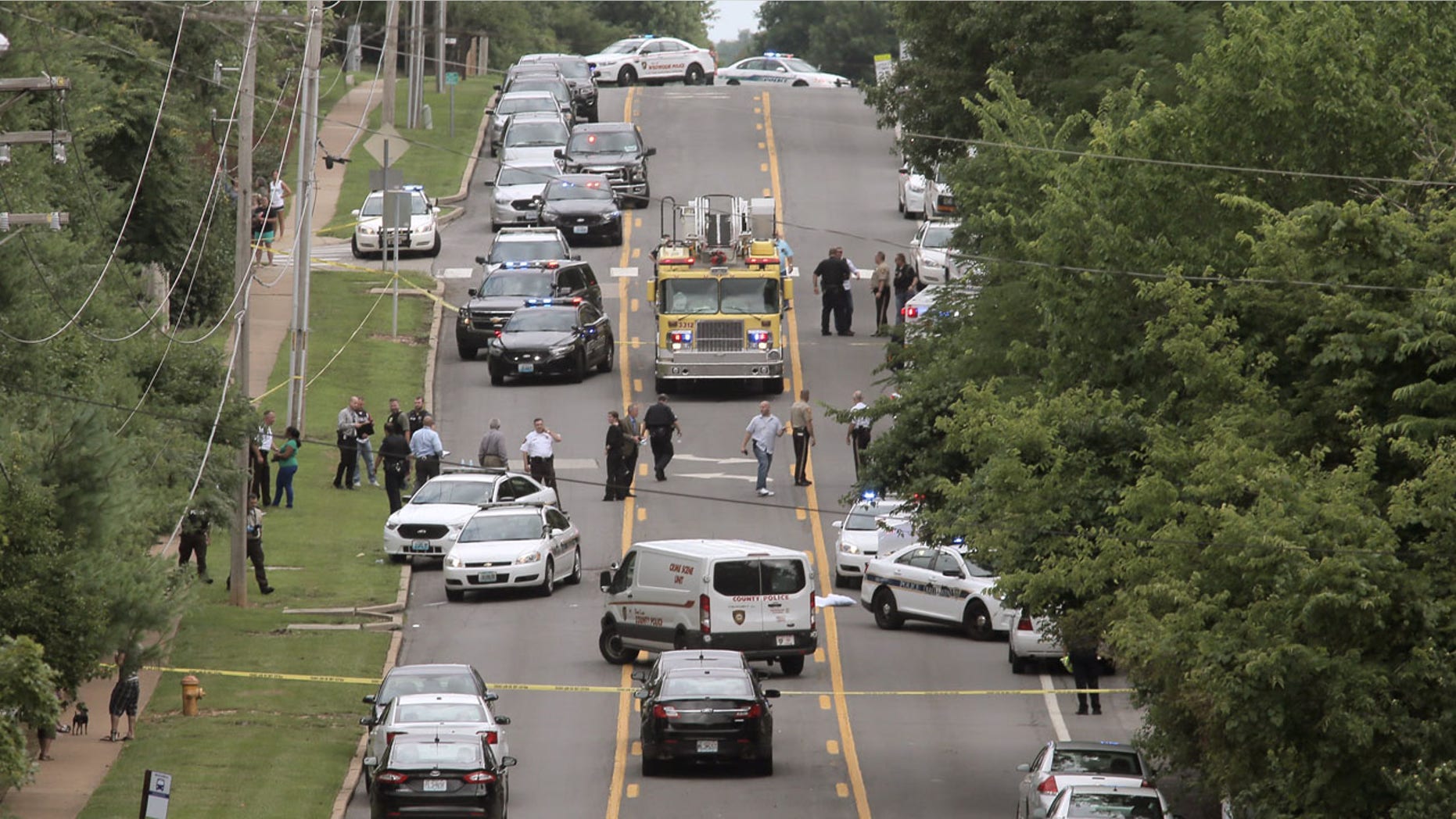 July 8, 2016: Police investigate a scene in Ballwin, Mo. after a police officer was shot during a confrontation with a man on a street.