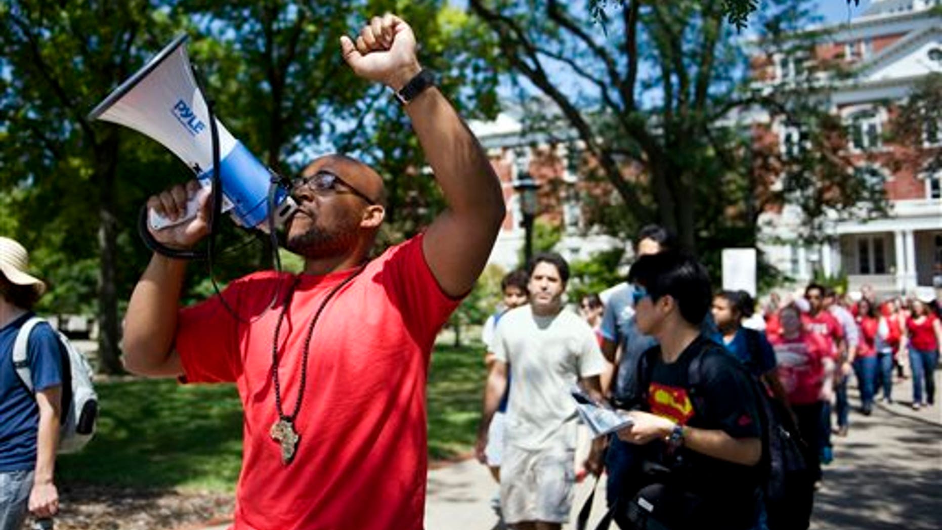 In this Aug. 26, 2015 photo, Jonathan Butler uses a megaphone during a "day of action" demonstration to draw attention to graduate students' demands in front of Jesse Hall on the University of Missouri campus in Columbia, Mo. Butler began his hunger strike on Nov. 2 to call attention to racial problems at the state's flagship university. (Daniel Brenner/Columbia Daily Tribune via AP) MANDATORY CREDIT
