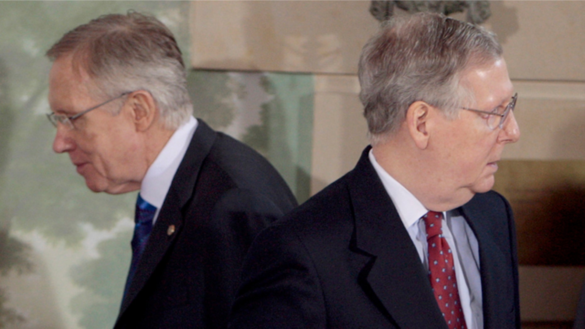 In this Feb. 25, 2010, file photo Senate Majority Leader Harry Reid of Nev., left, walks past Senate Minority Leader Mitch McConnell of Ky., during a meeting at the Blair House in Washington. Reid has promised he will not let GOP's health care repeal effort come up for debate on Senate floor, while McConnell says the Senate will vote on a bill to repeal ObamaCare.