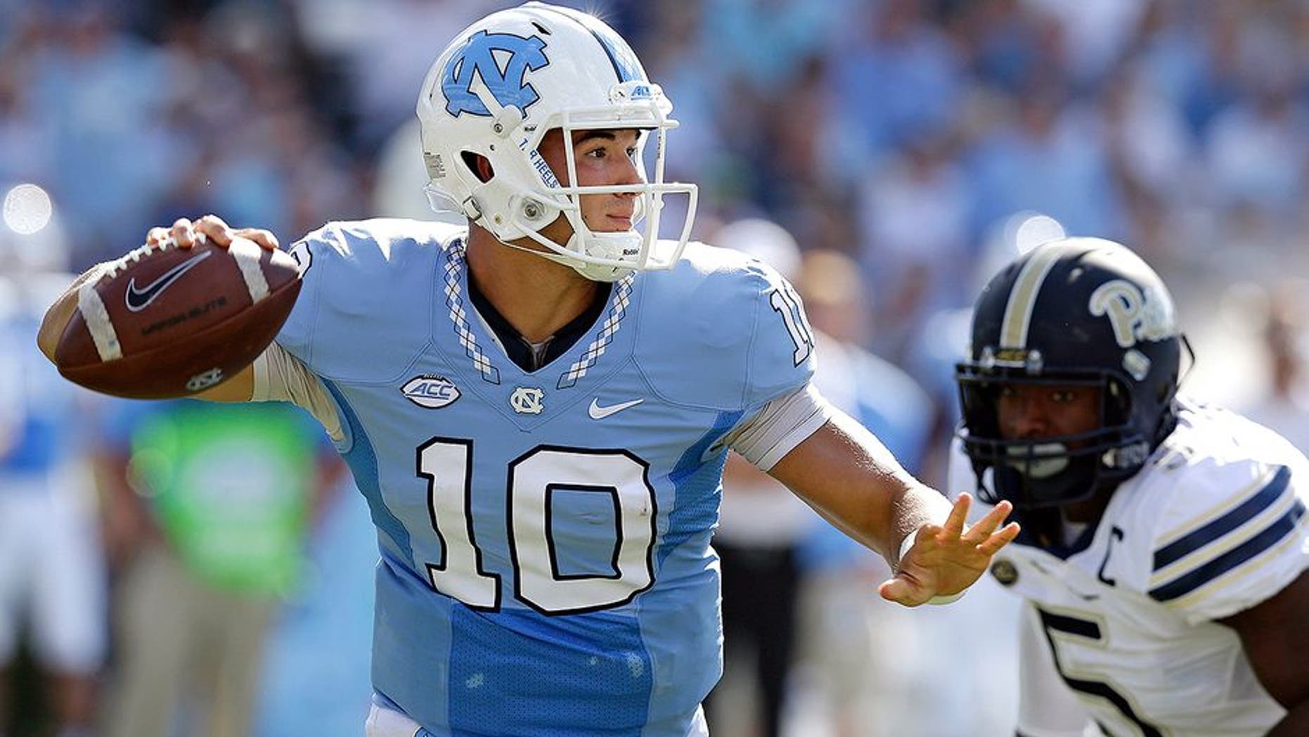FILE - In this Sept. 24, 2016, file photo, North Carolina quarterback Mitch Trubisky (10) throws a pass as Pittsburgh's Ejuan Price (5) rushes during the first half of an NCAA college football game in Chapel Hill, N.C. Trubisky has thrown for at least 400 yards in three straight games entering Saturday's visit from No. 25 Virginia Tech. (AP Photo/Gerry Broome, File)