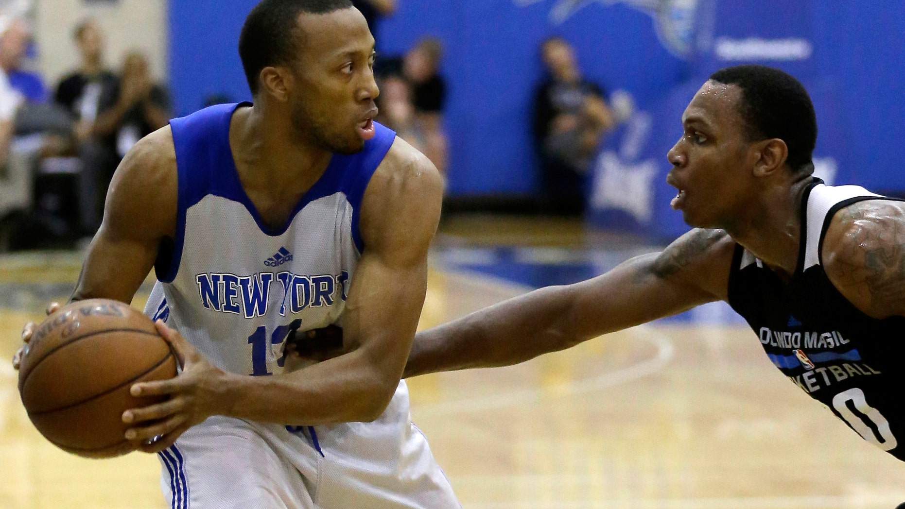 July 6, 2016: This is a file photo of New York Knicks' Akil Mitchell, left, as he looks to pass the ball around Treveon Graham.