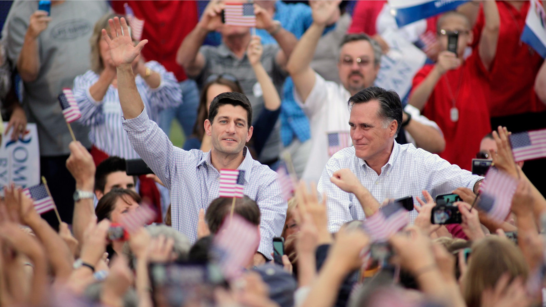 WAUKESHA, WI - AUGUST 12: Republican presidential candidate and former Massachusetts Gov. Mitt Romney and vice presidential candidate and Wisconsin native Rep. Paul Ryan (R-WI) (L) greet supporters during a campaign event at the Waukesha Expo Center on August 12, 2012 in Waukesha, Wisconsin. Romney continues his four day bus tour a day after announcing his running mate, Rep. Paul Ryan. (Photo by Darren Hauck/Getty Images)