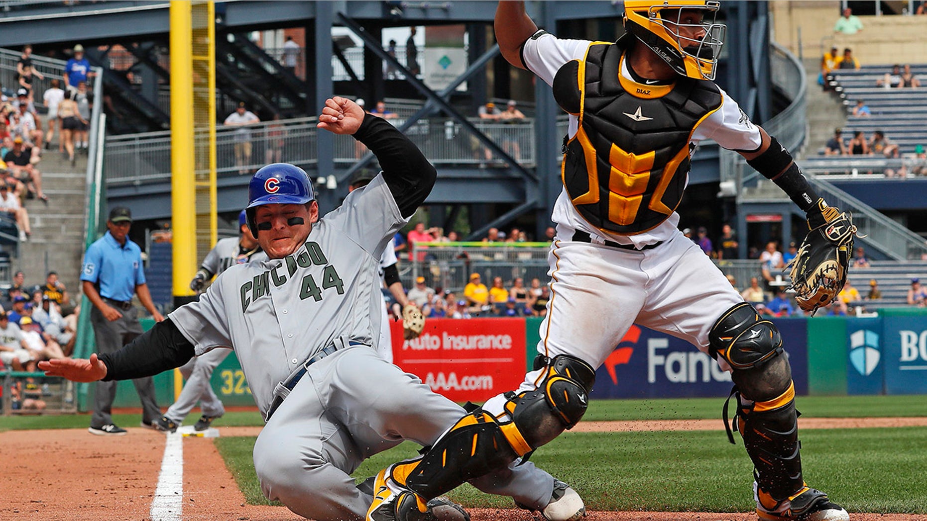 Pittsburgh Pirates catcher Elias Diaz, right, throws to first after getting the force-out at home plate on Chicago Cubs' Anthony Rizzo (44) on a fielder's choice to shortstop by Cub's Chris Gimenez in the eighth inning of a baseball game in Pittsburgh.