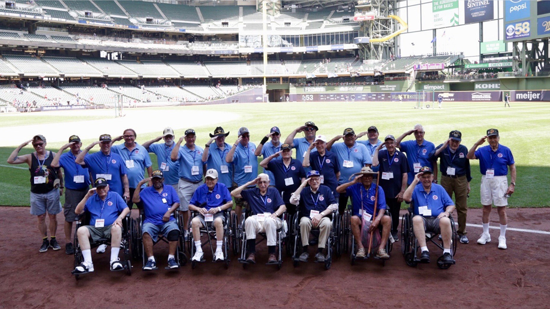 WWII vets in navy blue, Korean War vets in royal blue and Vietnam vets in light blue were honored at a Brewers game.