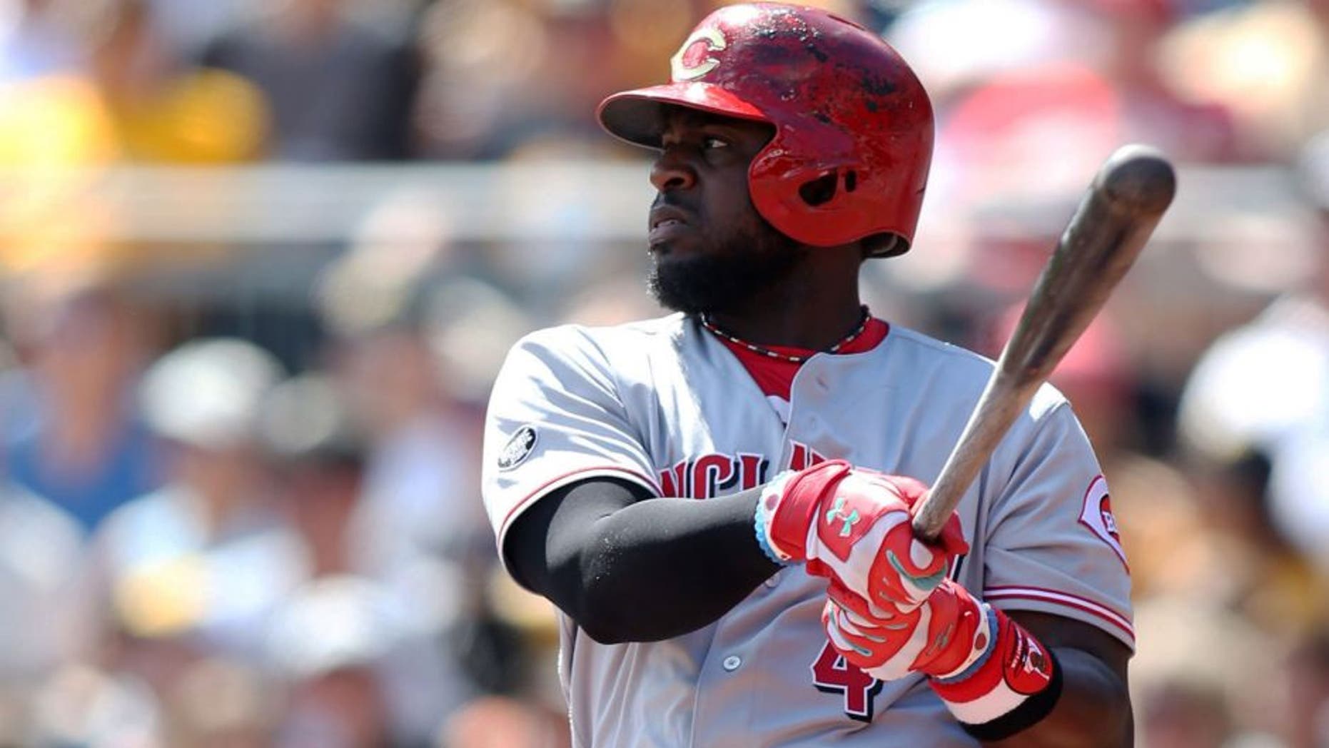Sep 11, 2016; Pittsburgh, PA, USA; Cincinnati Reds second baseman Brandon Phillips (4) hits an RBI single against the Pittsburgh Pirates during the second inning at PNC Park. Mandatory Credit: Charles LeClaire-USA TODAY Sports