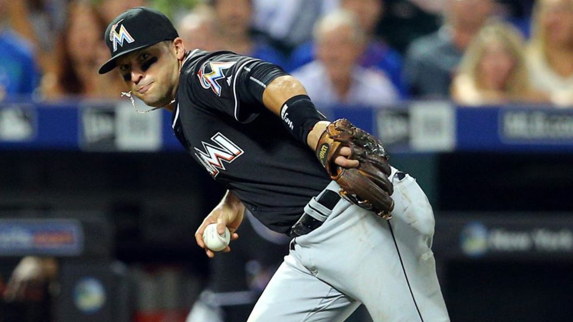 Aug 30, 2016; New York City, NY, USA; Miami Marlins third baseman Martin Prado (14) bare hands a ground ball and throws out New York Mets catcher Rene Rivera (not pictured) to end the fifth inning at Citi Field. Mandatory Credit: Brad Penner-USA TODAY Sports