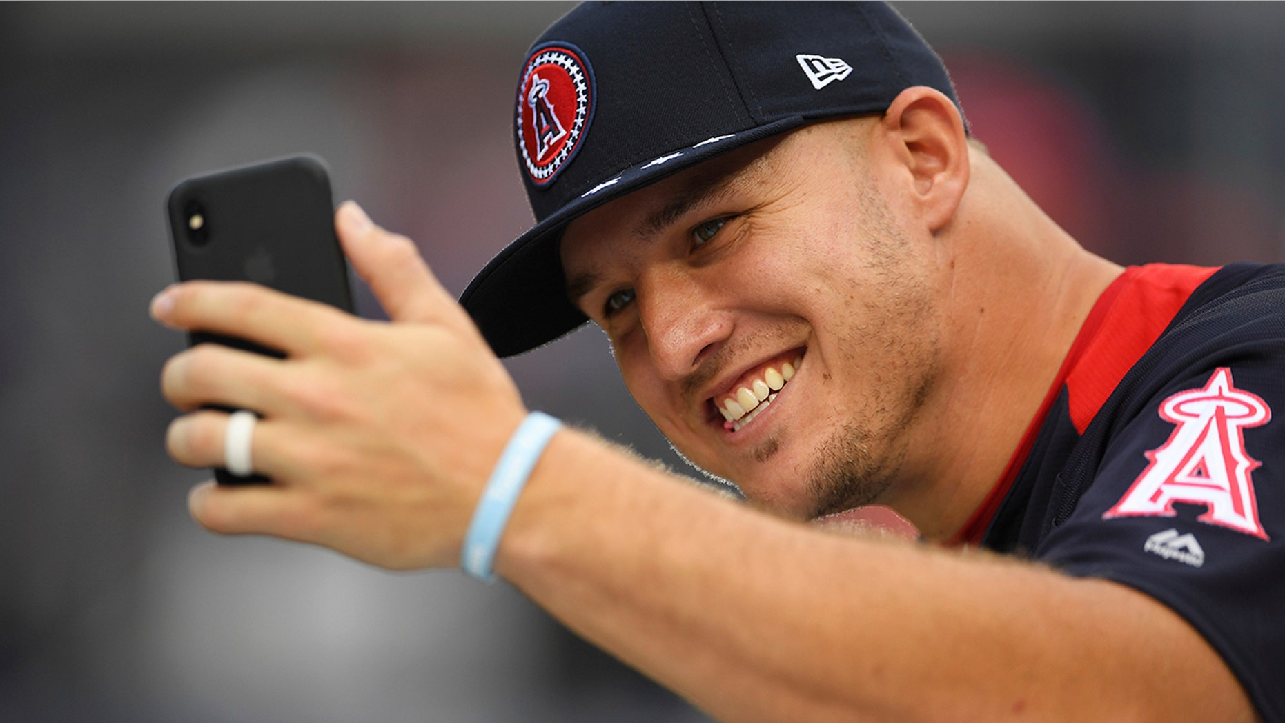 Los Angeles Angels outfielder Mike Trout takes a photo on the field ahead of the Home Run derby during the All-Star Game festivities.