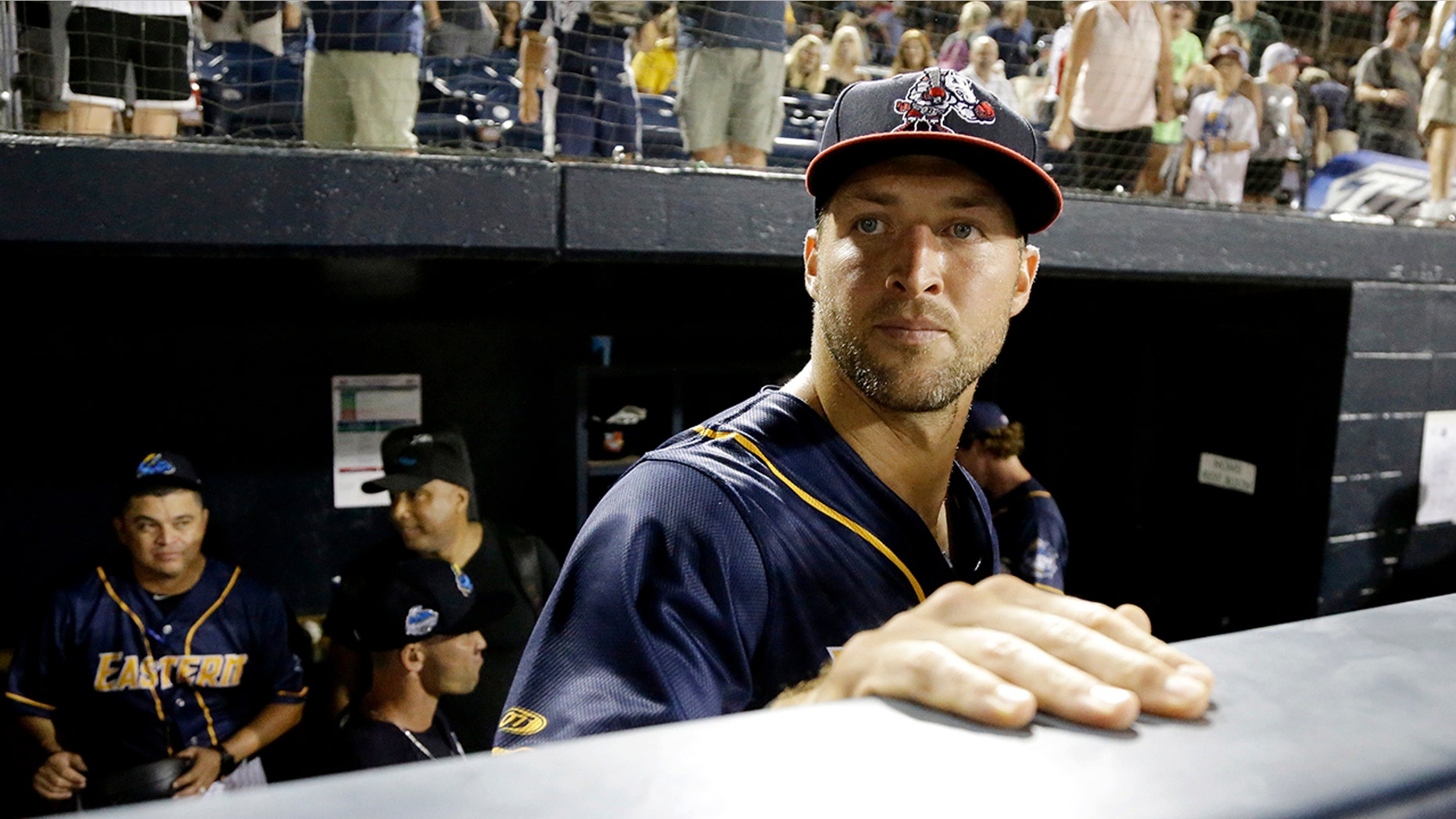 Eastern Division's Tim Tebow watches from the dugout after the Eastern League All-Star Double-A baseball game.