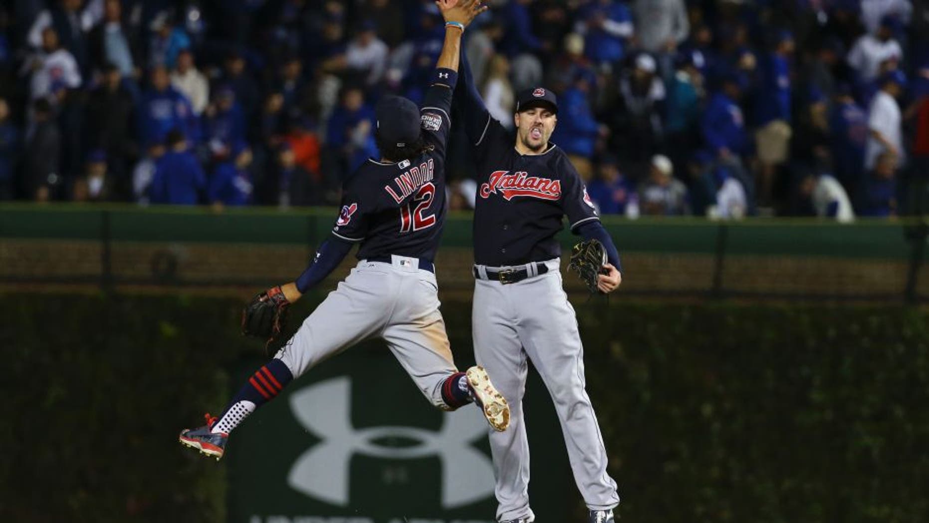 Oct 29, 2016; Chicago, IL, USA; Cleveland Indians shortstop Francisco Lindor (12) celebrates with right fielder Lonnie Chisenhall (right) after game four of the 2016 World Series against the Chicago Cubs at Wrigley Field. The Indians defeated the Cubs 7-2. Mandatory Credit: Jerry Lai-USA TODAY Sports