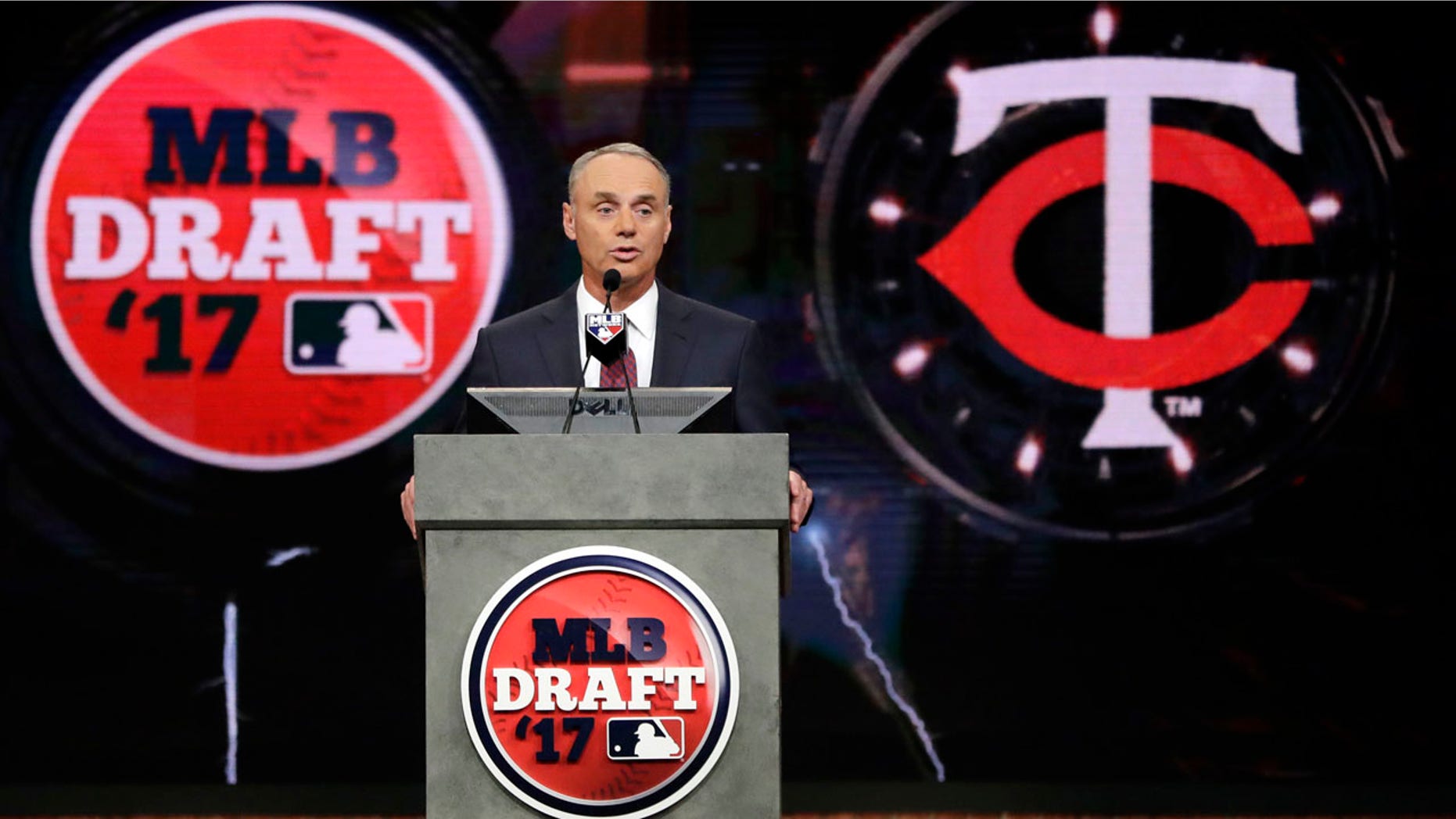 Commissioner Rob Manfred announces the Minnesota Twins selection of Royce Lewis, a shortstop and outfielder from JSerra Catholic High School in San Juan Capistrano, Calif., with the No. 1 pick in the first round of the Major League Baseball draft, Monday, June 12, 2017, in Secaucus, N.J. (AP Photo/Julio Cortez)