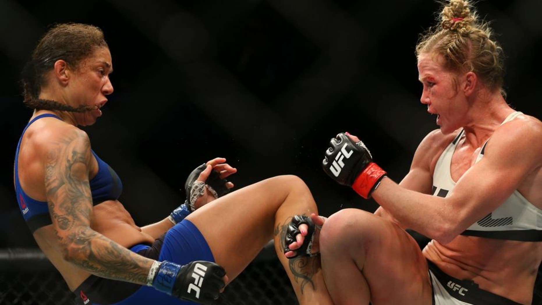 Feb 11, 2017; Brooklyn, NY, USA; Holly Holm (red gloves fights Germaine de Randamie (blue gloves) during UFC 208 at Barclays Center. Mandatory Credit: Ed Mulholland-USA TODAY Sports
