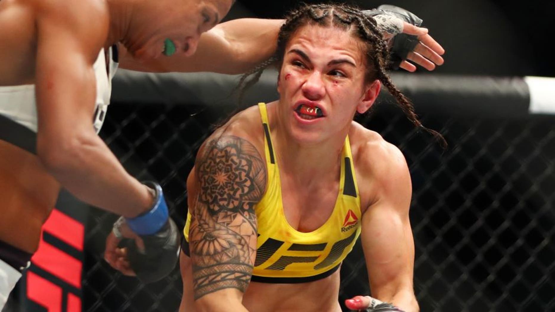 Feb 4, 2017; Houston, TX, USA; Jessica Andrade (red gloves) fights Angela Hill (blue gloves) during UFC Fight Night at Toyota Center. Mandatory Credit: Mark J. Rebilas-USA TODAY Sports