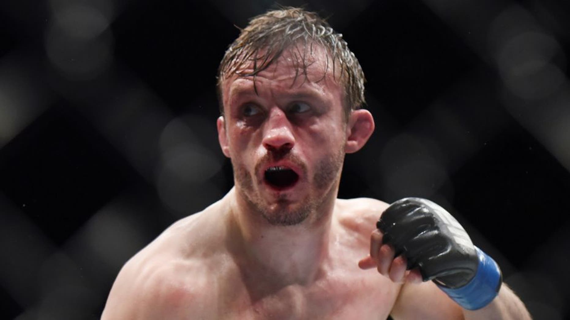 Feb 27, 2016; London, United Kingdom; Brad Pickett (blue gloves) reacts during his fight against Francisco Rivera during UFC Fight Night at O2 Arena. Mandatory Credit: Per Haljestam-USA TODAY Sports
