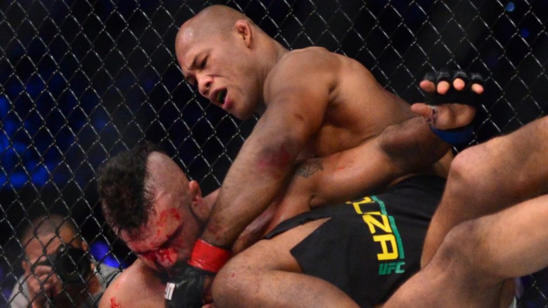 May 14, 2016; Curitiba, Brazil; Ronaldo Souza (red, top) throws punches down on Vitor Belfort (blue) during UFC Fight Night at Arena Atletico Paranaense. Mandatory Credit: Jason Silva-USA TODAY Sports