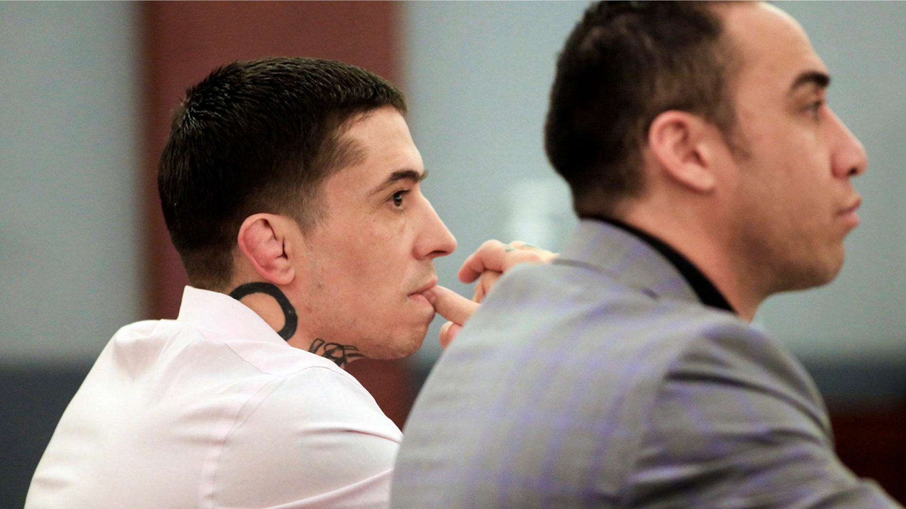 In this March 9, 2017 file photo, former mixed martial arts fighter War Machine, also known as Jonathan Koppenhaver, left, listens to testimony during his sexual assault and attempted murder trial at the Regional Justice Center in Las Vegas.