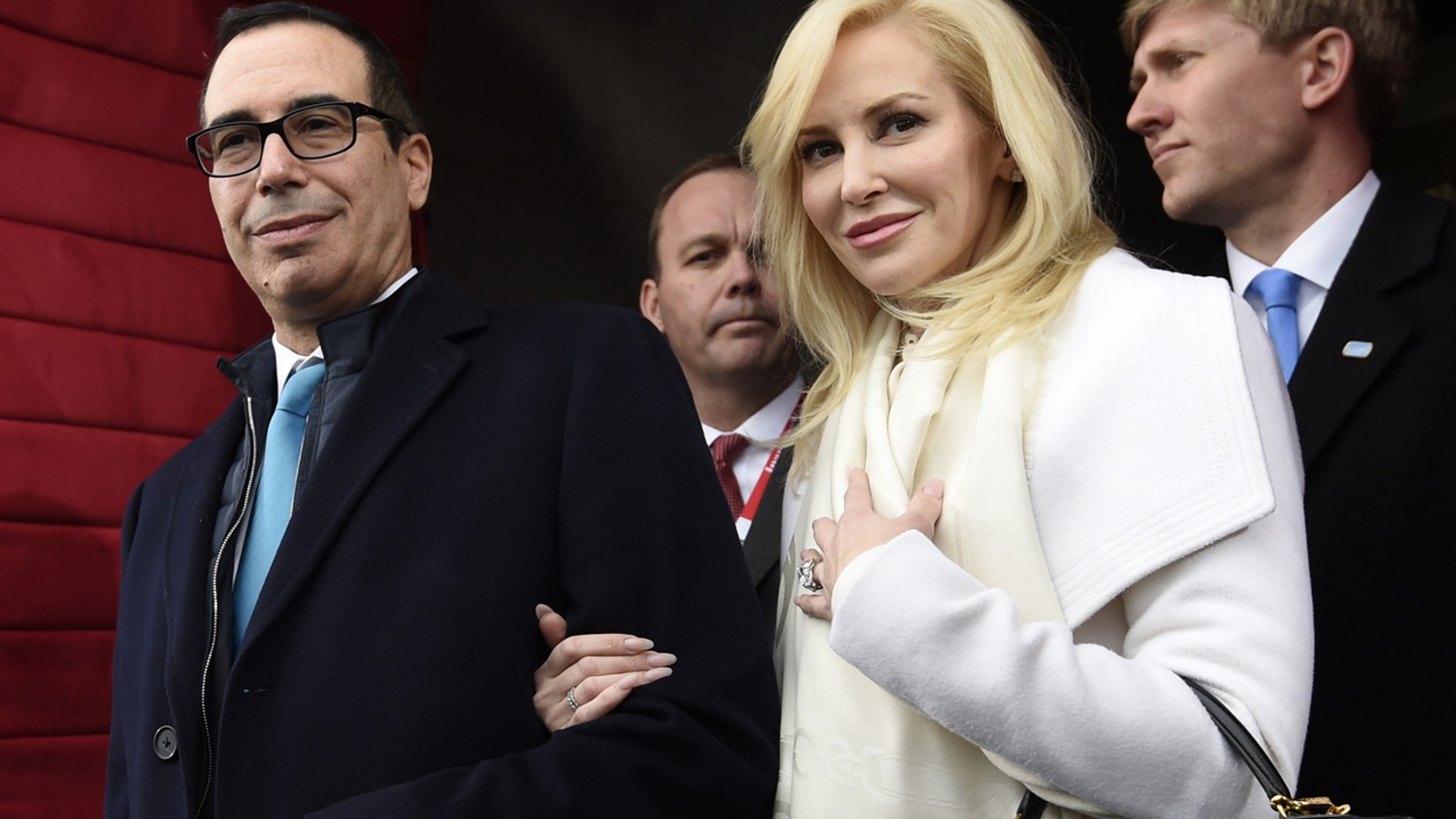 In this Friday, Jan. 20, 2017, file photo, Treasury Secretary-designate Stephen Mnuchin and his fiancee, Louise Linton, arrive on Capitol Hill in Washington, for the presidential inauguration of Donald Trump.
