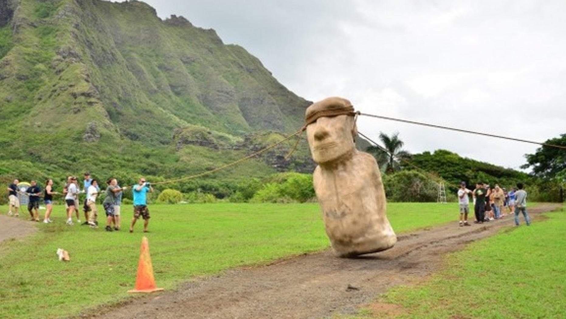 An Easter Island statue being walked into place