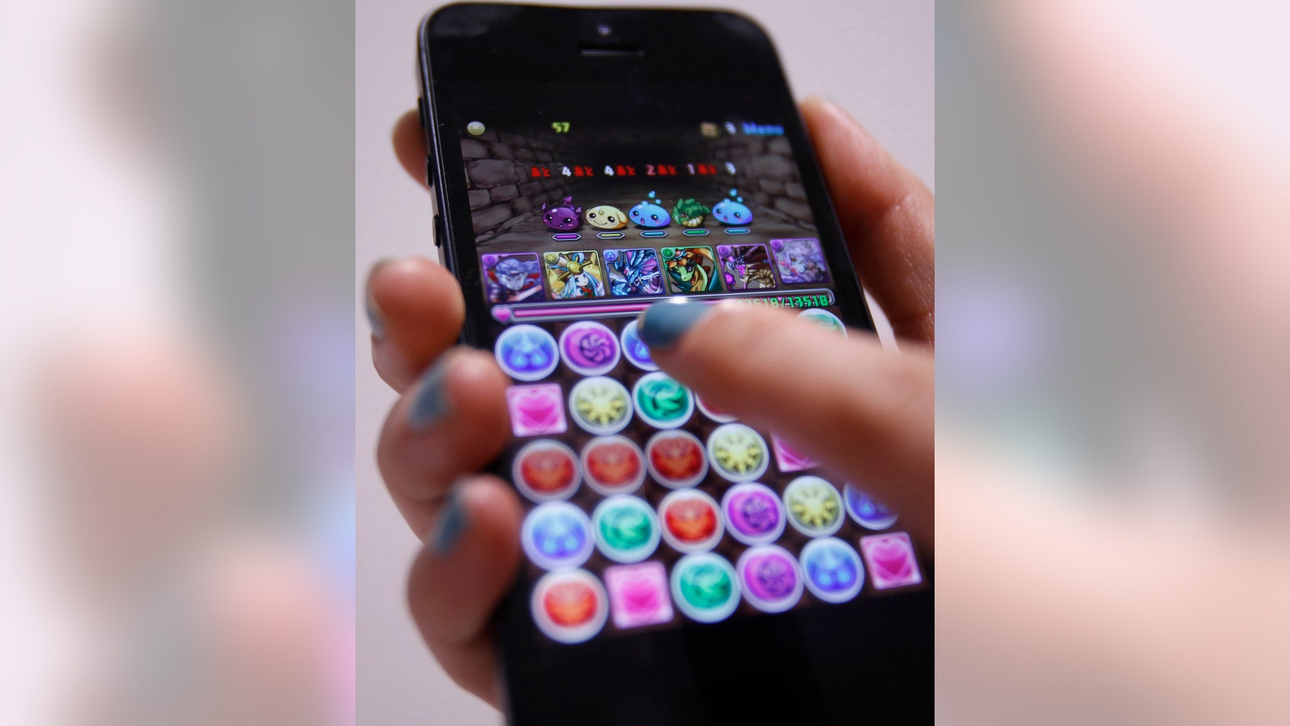 File photo: A iPhone demonstration of GungHo Online Entertainment Inc's mobile online game Puzzle and Dragons is pictured at the company's offices in Tokyo April 10, 2013. (REUTERS/Yuya Shino)