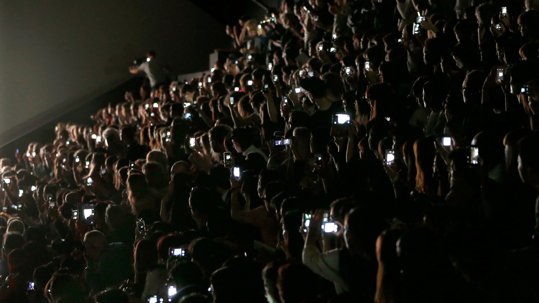 Guests and journalists take picture with their mobile phones during Japanese designer Yoshiyuki Miyamae Spring/Summer 2015 women's ready-to-wear collection show for fashion house Issey Miyake during Paris Fashion Week September 26, 2014. REUTERS/Charles Platiau (FRANCE - Tags: FASHION) - RTR47T3X